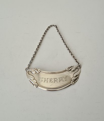 Bottle label in silver with the text "Sherry"