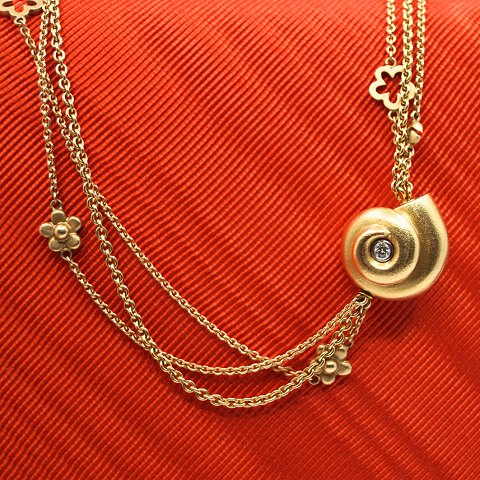Ole Lynggaard; A diamond snail clasp of 18k gold.