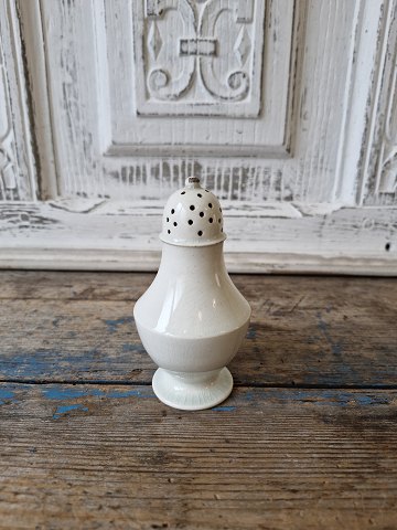 Antique cream-colored earthenware salt shaker