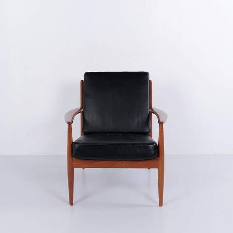 Model 118 armchair by Grete Jalk for France & Søn in teak and black leather from the 1960s