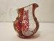 Jug / Cream jug
A red-and-white antique cream jug made of glass 
with a beautiful enamel painting as decoration
H: 9cm
About 1890
We have a large choice of antique glass
Please contact us for further information