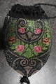 Antique Handmade bag, made of beads
This beautiful old handmade bag, from about the 
end of the 1800-years, is handmade of beads with 
embroidery which shows roses
The shape is with cords at the top that can tie 
the bag together and is the "handle"