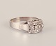 Swedish vintage 18 karat diamond ring in white gold adorned with four large diamonds and ten small diamonds. Classic Art Deco style.