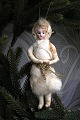 Old Christmas tree ornament from around 1900 in of a Christmas girl made of 
cotton wool...