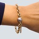 Antik 
Damgaard-
Lauritsen 
presents: 
Ole 
Lynggaard; 
Bracelet of 14k 
gold, with 
clasp in 18k 
white gold, set 
with ...