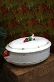 K&Co. presents: Antique, Swedish oval Christmas tureen in faience with a colored gnome lying on top of the lid...