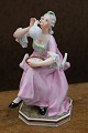 K&Co. presents: Bing & Grondahl porcelain figurine of a seated woman blowing soap bubbles, designed by Tegner...