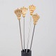 L'Art presents: Skultuna, set of four cocktail sticks with crown motif.