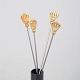 L'Art presents: Skultuna, set of four cocktail sticks with crown motif.