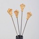 L'Art presents: Skultuna, set of four cocktail sticks with crown motif.
