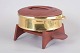 L'Art presents: Jens H. Quistgaard for Dansk Designs, brass casserole with exotic wood lid and stand.