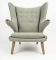 Lundin Antique presents: Wegner teddy bear chair with teak nails and oak legs. Needs reupholstering, we offer ...