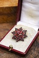 K&Co. presents: Old star shaped brooch with beautiful red garnets...