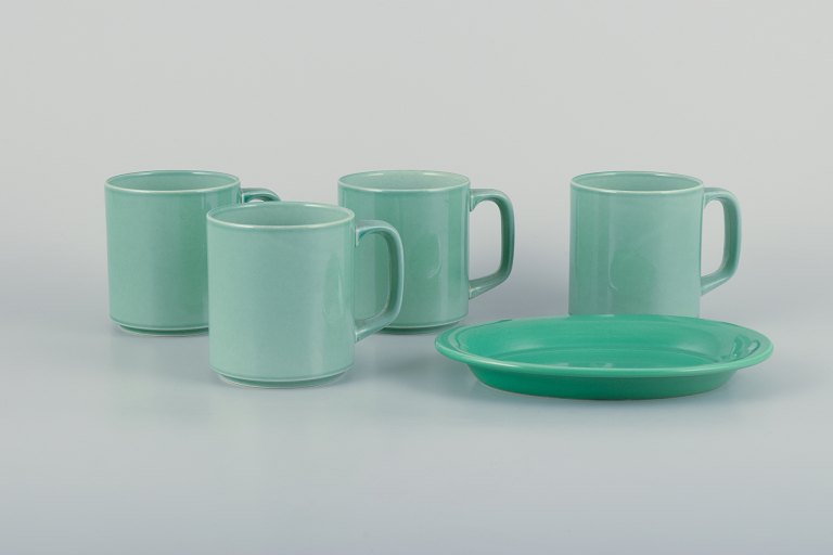 Royal Copenhagen, 4 All Seasons, four coffee mugs and a small oval dish in faience with green glaze.